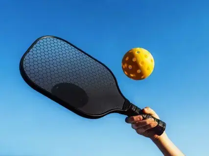 Close-up of a carbon fiber pickleball paddle face